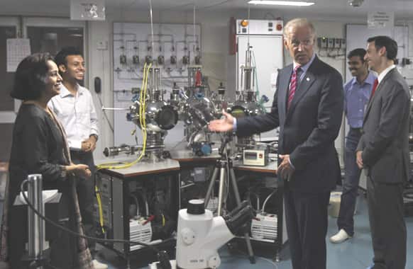 US Vice President Joe Biden, shares a light moment with students at a lab during his visit to the Indian Institute of Technology, in Powai, Mumbai.