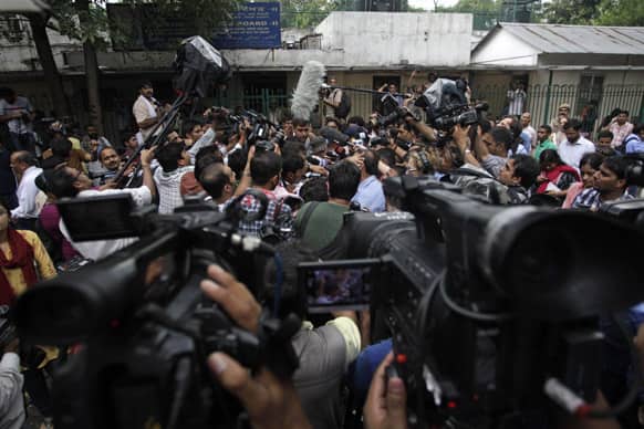 Media personnel gather around defense lawyer Rajesh Tiwari, unseen, outside a juvenile court in New Delhi.