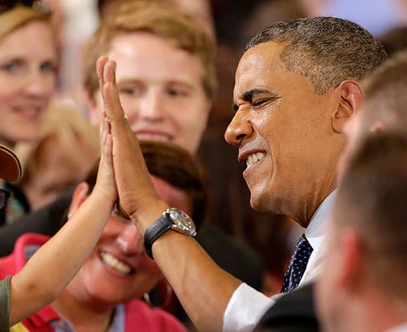 President Barack Obama gets a high five from a youngster after speaking about the economy, at the University of Central Missouri in Warrensburg, Mo.