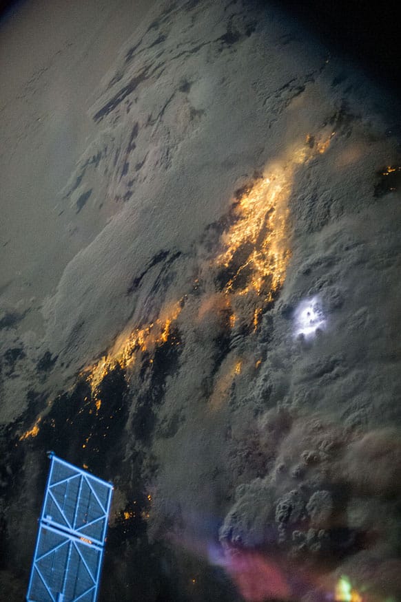 This image provided by NASA taken by one of the crew members aboard the International Space Station photographed this night view of storm clouds over Southern California. Early morning lightning can be seen as a white blotch just to the right of center.