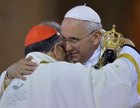 Pope Francis embraces Brazilian Cardinal Raymundo Damasceno after the pontiff received from him the statue of the Virgin of Aparecida from during a Mass inside the Our Lady of Aparecida Basilica in Aparecida, Brazil.