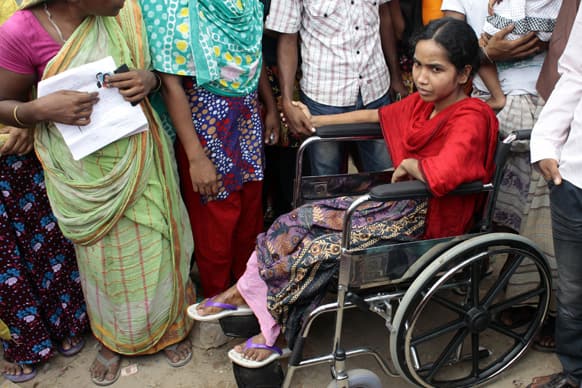 A Bangladeshi survivor of the Rana Plaza building collapse that killed over 1,000 people, sits in a wheelchair during a protest marking the three-month anniversary of the accident in Savar, near Dhaka, Bangladesh.