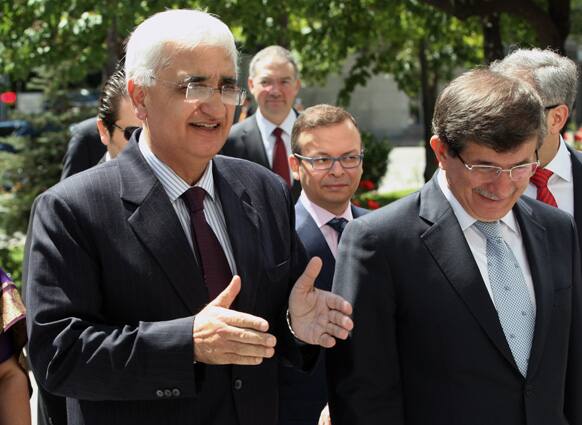 Turkish Foreign Minister Ahmet Davutoglu welcomes his Indian counterpart Salman Khurshid on his arrival in Ankara, Turkey. India`s Foreign minister is in Turkey for a two-day official visit.
