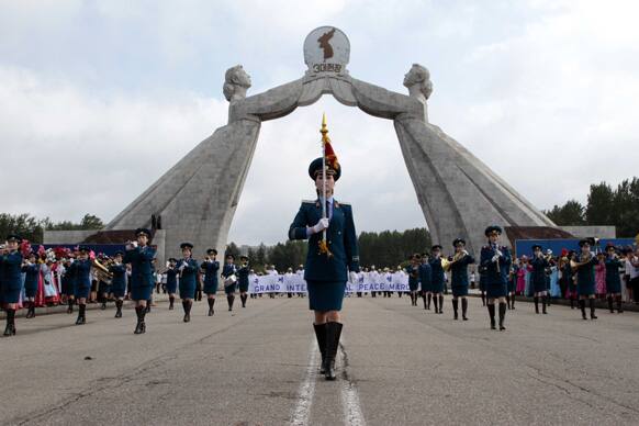 North Korean military band leads an international peace march at the Three Charters for National Reunification Memorial Tower in Pyongyang, North Korea.