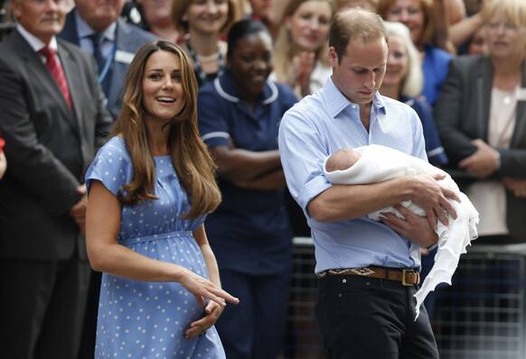 Britain`s Prince William and Kate, Duchess of Cambridge hold the Prince of Cambridge, as they pose for photographers outside St. Mary`s Hospital exclusive Lindo Wing in London where the Duchess gave birth on Monday July 22.