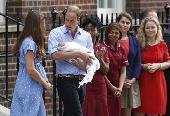 Britain`s Prince William and Kate, Duchess of Cambridge hold the Prince of Cambridge, as they pose for photographers outside St. Mary`s Hospital exclusive Lindo Wing in London where the Duchess gave birth on Monday July 22.