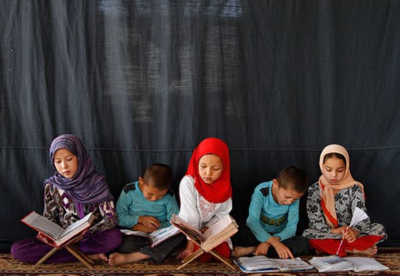 Afghan youths read the Quran during the Muslim holy month of Ramadan at a mosque in Kabul, Afghanistan.
