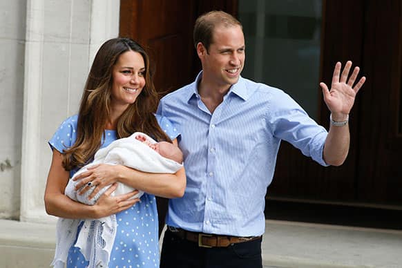 Britain`s Prince William, right, and Kate, Duchess of Cambridge, hold the Prince of Cambridge, as they pose for photographers outside St. Mary`s Hospital exclusive Lindo Wing in London where the Duchess gave birth on Monday July 22.