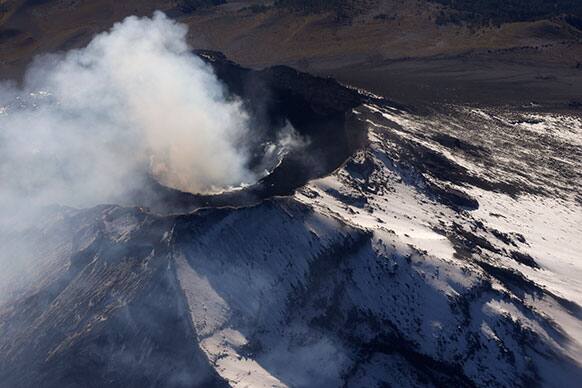 Smoke rises from the crater of the Popocatepetl volcano as seen from a Mexican Navy aircraft on a volcano monitoring mission in Mexico.