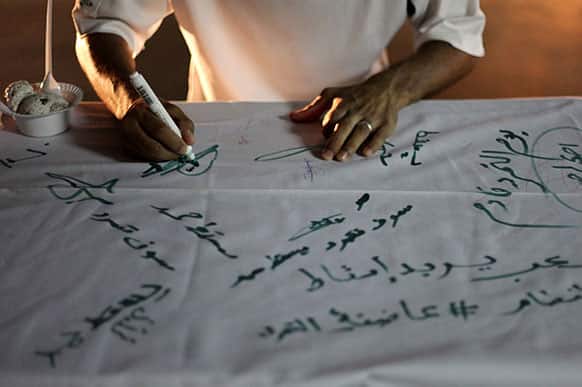 A Bahraini anti-government protester signs a petition, set up in a street in the western village of Malkiya, Bahrain.