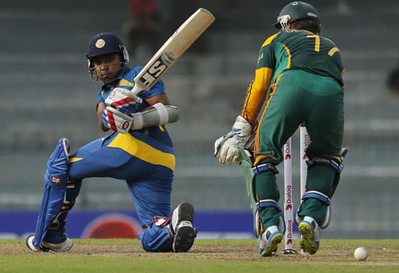 Sri Lankan cricketer Mahela Jayawardene bats as South African wicketkeeper AB de Villiers watches during their second one-day international cricket match in Colombo, Sri Lanka.