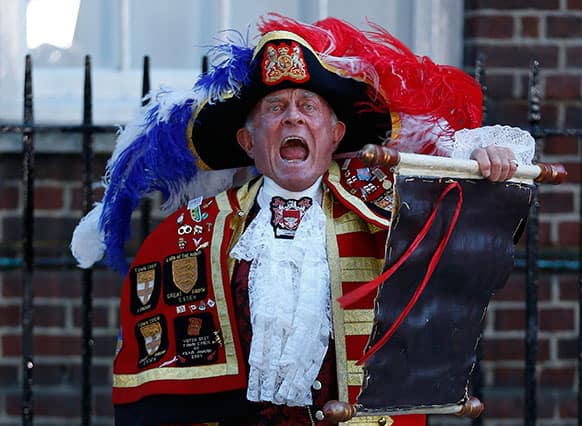 Tony Appleton, a town crier, announces the birth of the royal baby, outside St. Mary`s Hospital exclusive Lindo Wing in London. Palace officials say Prince William`s wife Kate has given birth to a baby boy.