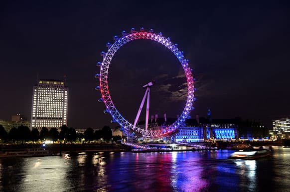 The London Eye observation wheel on the banks of the river Thames celebrates the birth of the Duke and Duchess of Cambridge`s son by lighting up in the national colors of red, white and blue.