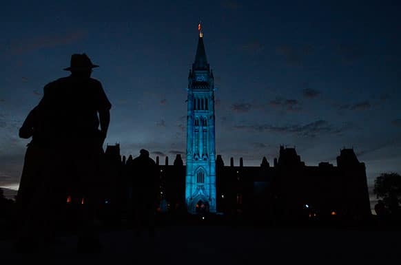 The Peace tower and Parliament buildings in Ottawa, Ontario are illuminated in royal blue to celebrate the birth of the royal baby on Monday July 22, 2013.