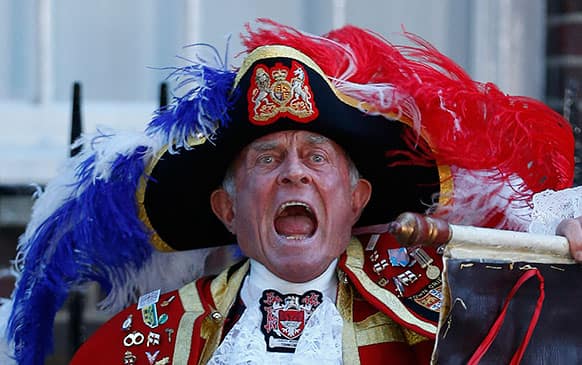 Tony Appleton, a town crier, announces the birth of the royal baby, outside St. Mary`s Hospital exclusive Lindo Wing in London. Palace officials say Prince William`s wife Kate has given birth to a baby boy. The baby was born at 4:24 p.m. and weighs 8 pounds 6 ounces.