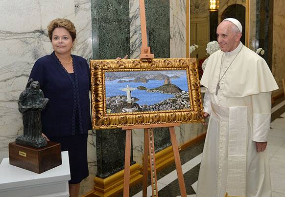 Pope Francis stands next to a gift alongside Brazil`s President Dilma Rousseff during his welcome ceremony at Guanabara Palace in Rio de Janeiro, Brazil.