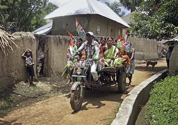 Villagers arrive in a modified motorcycle to cast their votes for elections to the local administrative body at Dhultikuri in Birbhum district of West Bengal state, India.