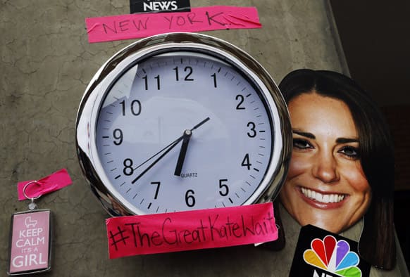 A mask depicting Britain`s Duchess of Cambridge and a clock showing New York time, which were placed by members of the media, is seen across St. Mary`s Hospital exclusive Lindo Wing in London.