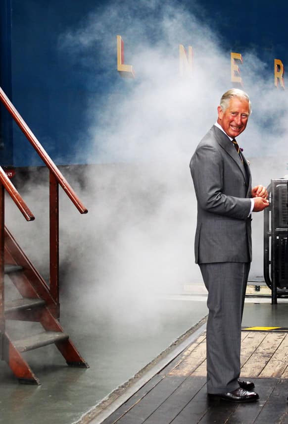 Britain`s Prince Charles arrives on the Bittern steam locomotive as he visits the National Railway Museum in York, Britain.