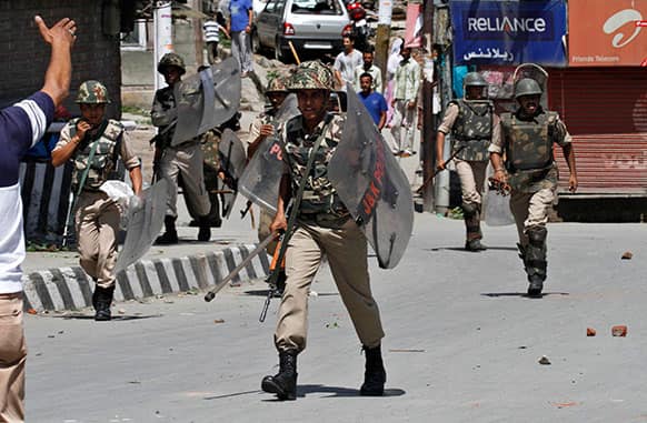 Indian paramilitary soldiers arrive during a protest against the recent killing of four villagers in Srinagar.
