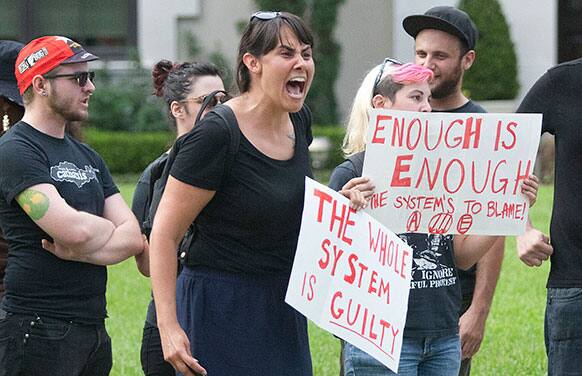 Protestors shout at counter-protestors across the street on Del Monte Dr. in the River Oaks community in Houston.