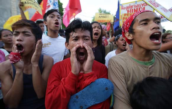 Filipino protesters shout slogans as they tried to get closer to the house of Philippine President Benigno Aquino III in suburban Quezon city, north of Manila.