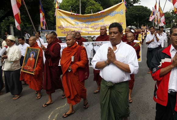 Myanmar Buddhist monks and others march during a protest against recent bombing in Buddha Gaya, in Yangon, Myanmar.