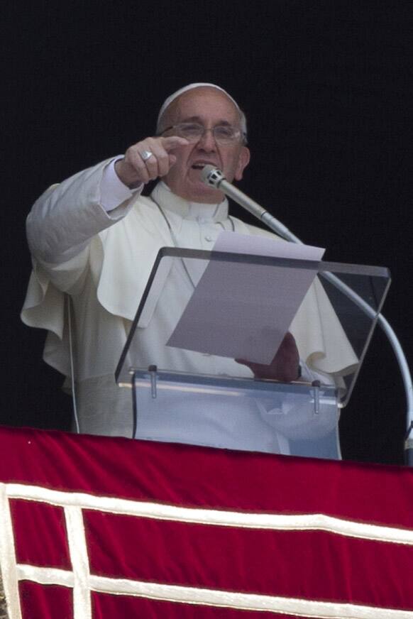 Pope Francis delivers his speech during the Angelus noon prayer he celebrated from the window of his studio overlooking St. Peter`s Square, at the Vatican.