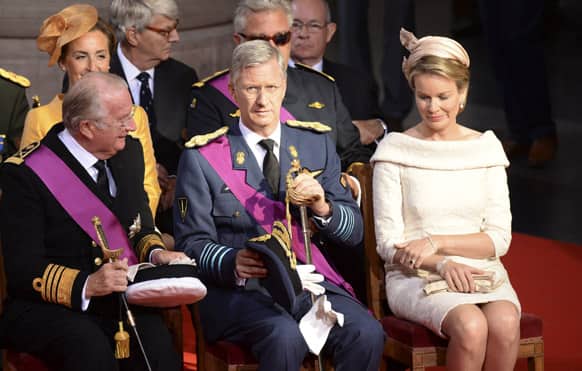 Belgium`s King Albert II, left, Prince Philippe, center, and his wife Princess Mathilde attend a church service at the St. Gudule cathedral in Brussels.
