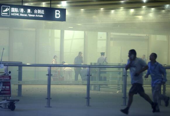 Medical workers and policemen work at the terminal 3 of the Beijing International Airport. Chinese state media said that a man set off a homemade bomb in Terminal 3 of the Beijing International Airport.