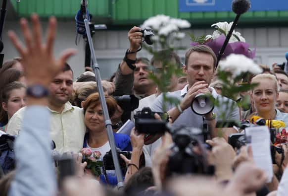 Russian opposition leader Alexei Navalny addresses supporters and journalists after arriving from Kirov at a railway station in Moscow.