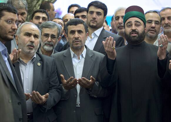 Iranian President Mahmoud Ahmadinejad, center, prays at the holy shrine of Imam Abbas in Karbala, Iraq.