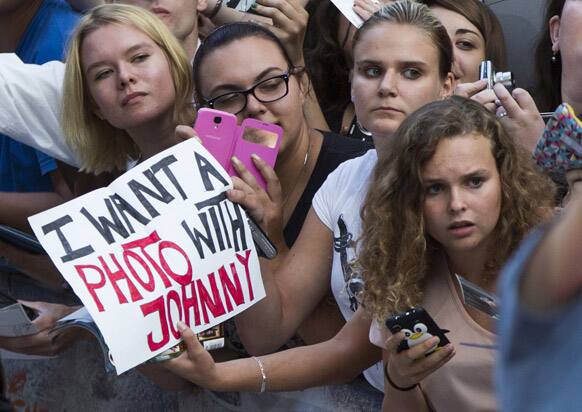 Fans hold a placard reading