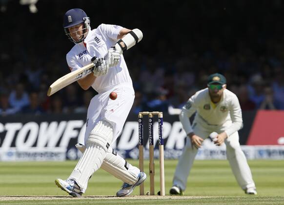 England`s Graeme Swann plays a shot off the bowling of Australia`s Ryan Harris during day two of the second Ashes Test at Lord`s cricket ground in London.