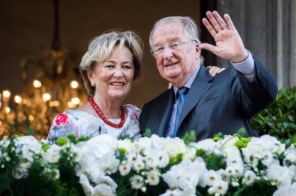 Belgium`s King Albert II and Queen Paola wave to the crowd as they stand on the balcony of the City Hall in Liege, Belgium, during the last day of their 3-day farewell tour.
