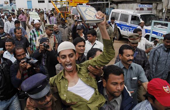 Police detains an activist of Darsgah Jihad-o-Shahadat as he shouts slogans during a protest after Friday prayers in Hyderabad.