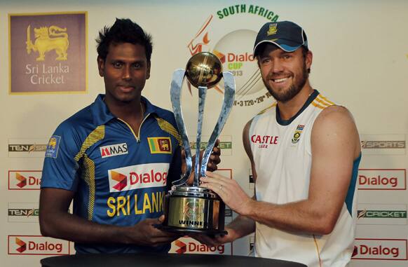 Sri Lanka`s captain Angelo Mathews and South Africa’s captain AB de Villiers pose with the winner’s Dialog Cup 2013 ahead of their first ODI cricket match between them in Colombo, Sri Lanka.