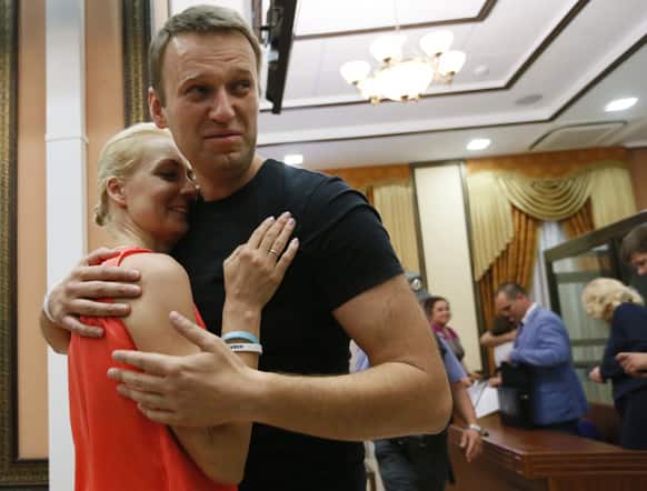 Russian opposition leader Alexei Navalny embraces his wife Yulia, as he was released in a courtroom in Kirov, Russia.