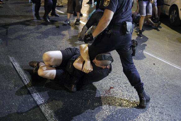 Police clash with protestors during a demonstration against the government in front of the People`s Party headquarter in Madrid, Spain.