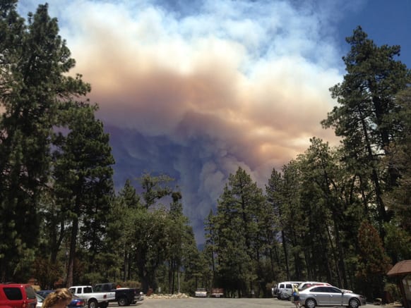 Wildfire smoke billowing over the Idyllwild Arts Academy in Idyllwild, Calif. The blaze about 100 miles east of Los Angeles had grown to more than 35 square miles in size and had destroyed at least six houses and mobile homes.