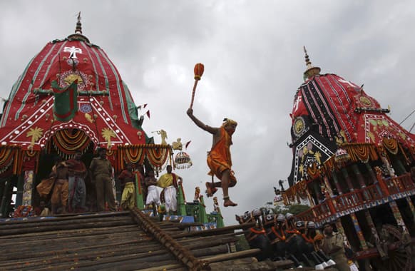 A traditional temple dancer dressed as god Hanuman performs near chariots ahead of the return of chariots event that marks the end of the nine day chariot festival of Lord Jagannath in Puri, Orissa.