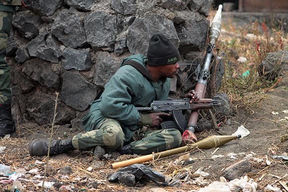 A Congolese government soldier mans a position at the front line, near the eastern city of Goma, Congo. Government forces continued their slow advance Wednesday in a fourth day of fighting against M23 rebels.