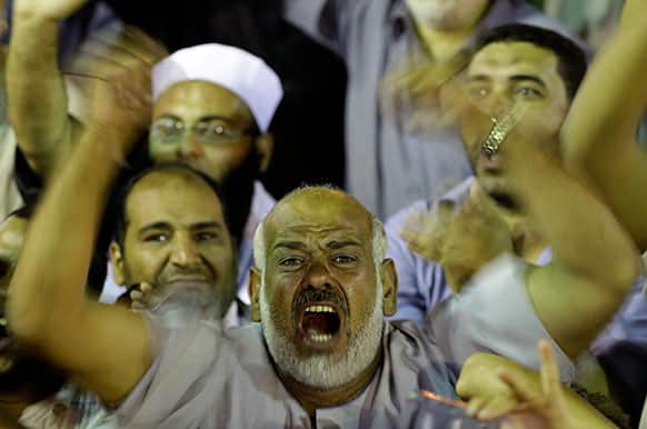 A supporter of the ousted President Mohammed Morsi shouts slogans during a demonstration in front of Cairo University, where protesters have installed their camp in Giza, southwest of Cairo, Egypt.