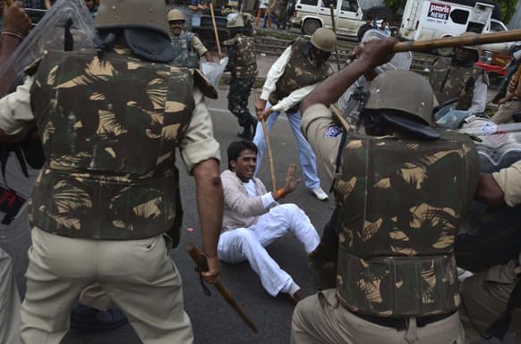Policemen beat an activist of National Student Union of India (NSUI) demonstrating against the Bharatiya Janata Party lead Madhya Pradesh state government in Bhopal.