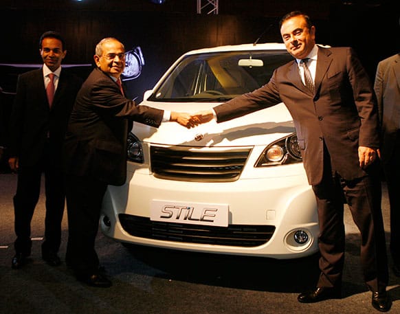 Renault Nissan CEO Carlos Ghosn, shakes hands with Hinduja group chairman G.P.Hinduja, center as Ashok Leyland Chairman Dheeraj Hinduja, left watches during the unveiling of light commercial vehicle ‘Stile’ in Chennai.
