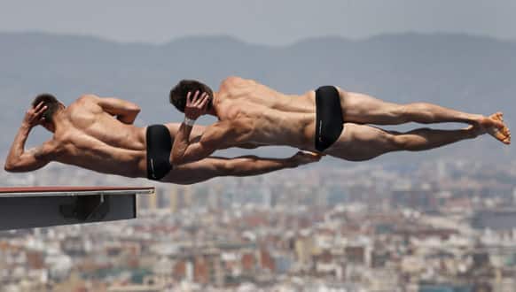 Patrick Hausding and Sascha Klein from Germany perform during a 10-meter platform diving training session at the FINA World Championships in Barcelona, Spain.