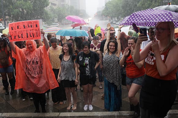 Abortion rights demonstrators rally outside of the State Capitol to protest recent legislation that could shut down all but five clinics and restrict abortion rights throughout the state in Austin, Texas.
