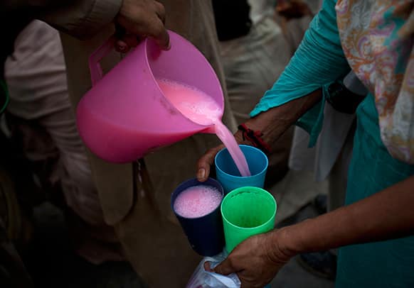 A Pakistani woman receives milk, sweetened with fruit juice, for Iftar to break the fast during the Muslim holy fasting month of Ramadan in Rawalpindi, Pakistan.
