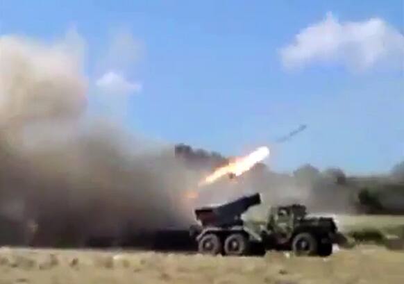 In this image taken from leaked video obtained by Ugarit News and posted on Monday, July 15, 2013, which has been authenticated based on its contents and other AP reporting, purports to show forces loyal to President Bashar Assad firing rockets into Homs, Syria.