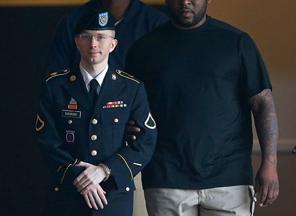 rmy Pfc. Bradley Manning is escorted to a waiting security vehicle outside of a courthouse in Fort Meade, Md., after appearing for a hearing at his court martial.